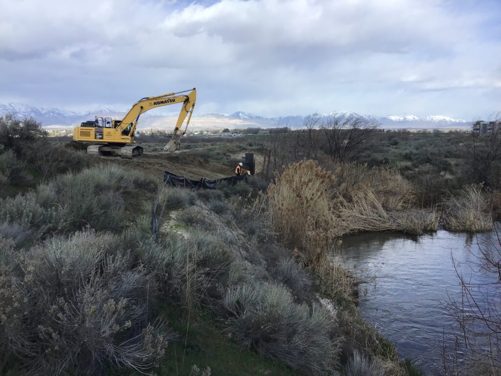 Construction work being performed on the embankment of Corner Canyon Creek